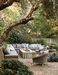 an outdoor living area with couches, chairs and tables in the middle of it