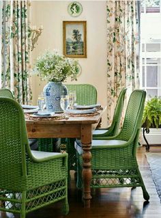 a dining room with green chairs and a table