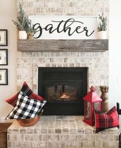 a fireplace decorated for christmas with plaid pillows and other holiday decorations on the mantel