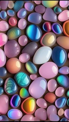 an image of many different colored rocks in the shape of hearts on a brown background