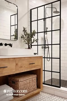 the bathroom is decorated in white and black with wood cabinets, tile flooring, and an open shower