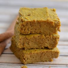 three pieces of pumpkin bread stacked on top of each other with cinnamon sticks next to them