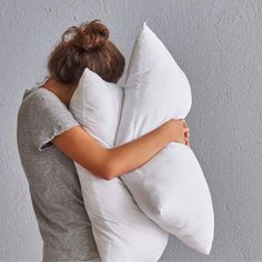 a woman hugging a pillow on her back