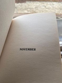 an open book with the word november printed on it