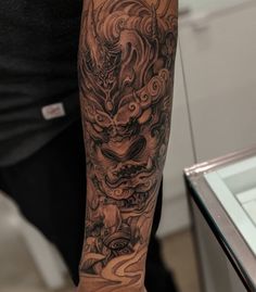 a man with a dragon tattoo on his arm