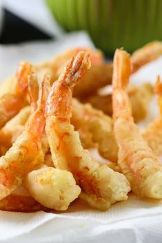 some fried shrimp sticks are sitting on a napkin