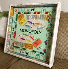 a monopoly board sitting on top of a couch