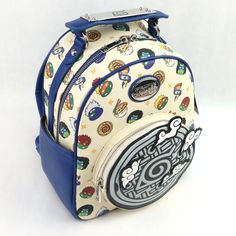 the back side of a blue and white backpack with various stickers all over it