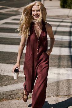 A true throw-on-and-go staple from free-est, this easy jumpsuit is the definition of a seasonless style. **Fit:** Relaxed, shapeless fit throughout with wide-leg design **Features:** Plunge halter neckline, low back, dropped armholes, front button-up closures, side pockets **Why We ❤ It:** Easy with sneakers or elevated with bold platforms, this style has endless ways to wear. | Harper Jumpsuit by free-est at Free People in Red, Size: L Red Relaxed Fit Jumpsuits And Rompers For Summer, Red Relaxed Fit Jumpsuit For Summer, Halter Neckline, New Tops, Low Back, Free Clothes, Boho Outfits, Knitwear, Latest Trends