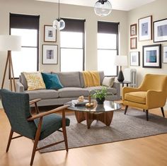 a living room filled with furniture and pictures on the wall