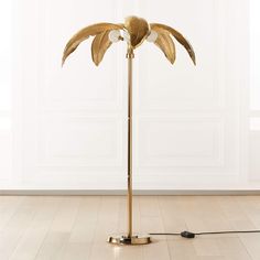 a floor lamp with a gold leaf design on it