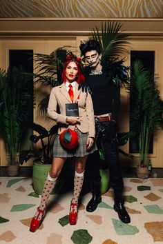 two people dressed in costumes posing for a photo