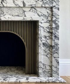 a white marble fireplace with a black door