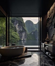 a large bathtub sitting in the middle of a bathroom next to a window with mountains behind it