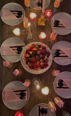 an overhead view of a table with plates and utensils set for a meal