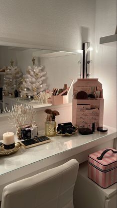 a white desk topped with a mirror and lots of drawers next to a shelf filled with items