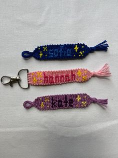 three crocheted key fobs on a white surface