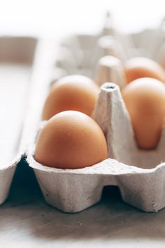 an egg carton filled with brown eggs