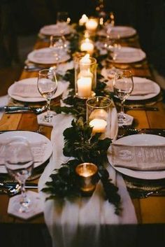 a long table is set with candles and place settings