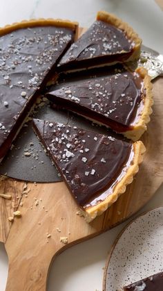 a chocolate tart on a wooden cutting board