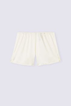 Shorts in light stretch silk satin with small side slits. Ideal to wear as a refined pair of shorts for night or as elegant loungewear. Satin Shorts For Loungewear, Satin Short Bottoms For Loungewear, Satin Lounge Shorts, Satin Bottoms For Loungewear, Satin Loungewear Bottoms Short Length, White Satin Bottoms For Summer, Satin Loungewear Shorts, Cream Silk Bottoms For Summer, Summer Silk Cream Bottoms