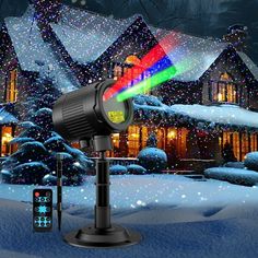 an image of a christmas light projector in the snow