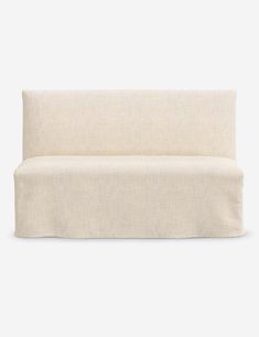 the back of a white couch on a gray background with no one sitting in it