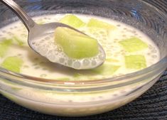 a glass bowl filled with pudding and a spoon