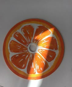 an orange cut in half sitting on top of a white counter next to a window