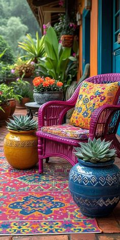 an outdoor patio with potted plants and colorful rugs on the floor, along with two wicker chairs