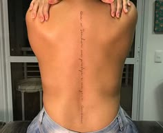 the back of a woman's body with writing on it