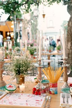 an image of a table setting with flowers and candles