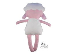 a pink and white stuffed animal with long legs, wearing a dress that is shaped like a sheep