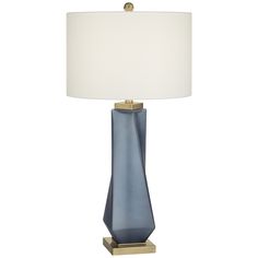 a blue table lamp with a white shade on the base and a gold plated metal base