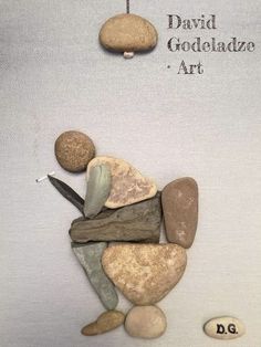 some rocks are arranged on top of each other and the words david goedeladze art above them