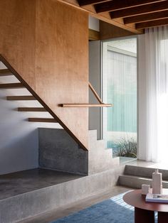 a living room filled with furniture and a stair case