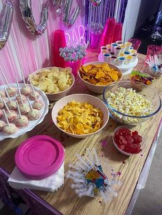 a table filled with lots of different types of snacks and desserts on top of it