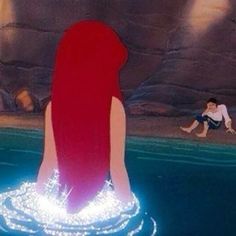 the little mermaid is floating in the water