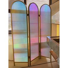 a room divider with three different colored glass panels on the front and back sides