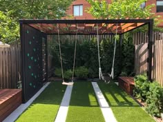 a backyard with artificial grass and swings