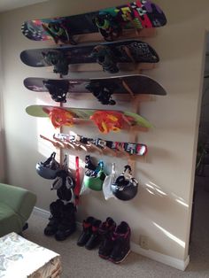 there are many skateboards and shoes hanging on the wall