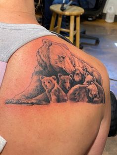 a woman with a bear and cubs tattoo on her shoulder