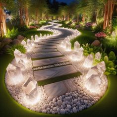 a garden with stones and lights on the ground, along side a path that leads to trees