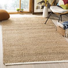 an area rug in a living room with a chair and window