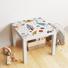 a child's play table with toys on the floor