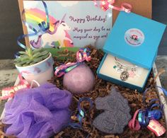 a box filled with lots of different items next to a sign and potted plant