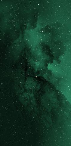 the night sky is filled with stars and green hues, as well as dark clouds