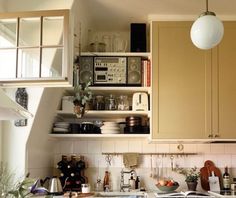 a kitchen filled with lots of clutter and cooking utensils on top of a counter