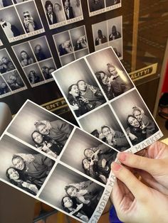 a person holding up some old photos in front of them