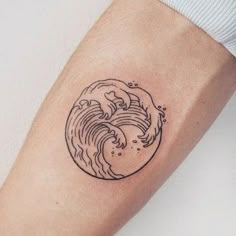 a small wave tattoo on the arm